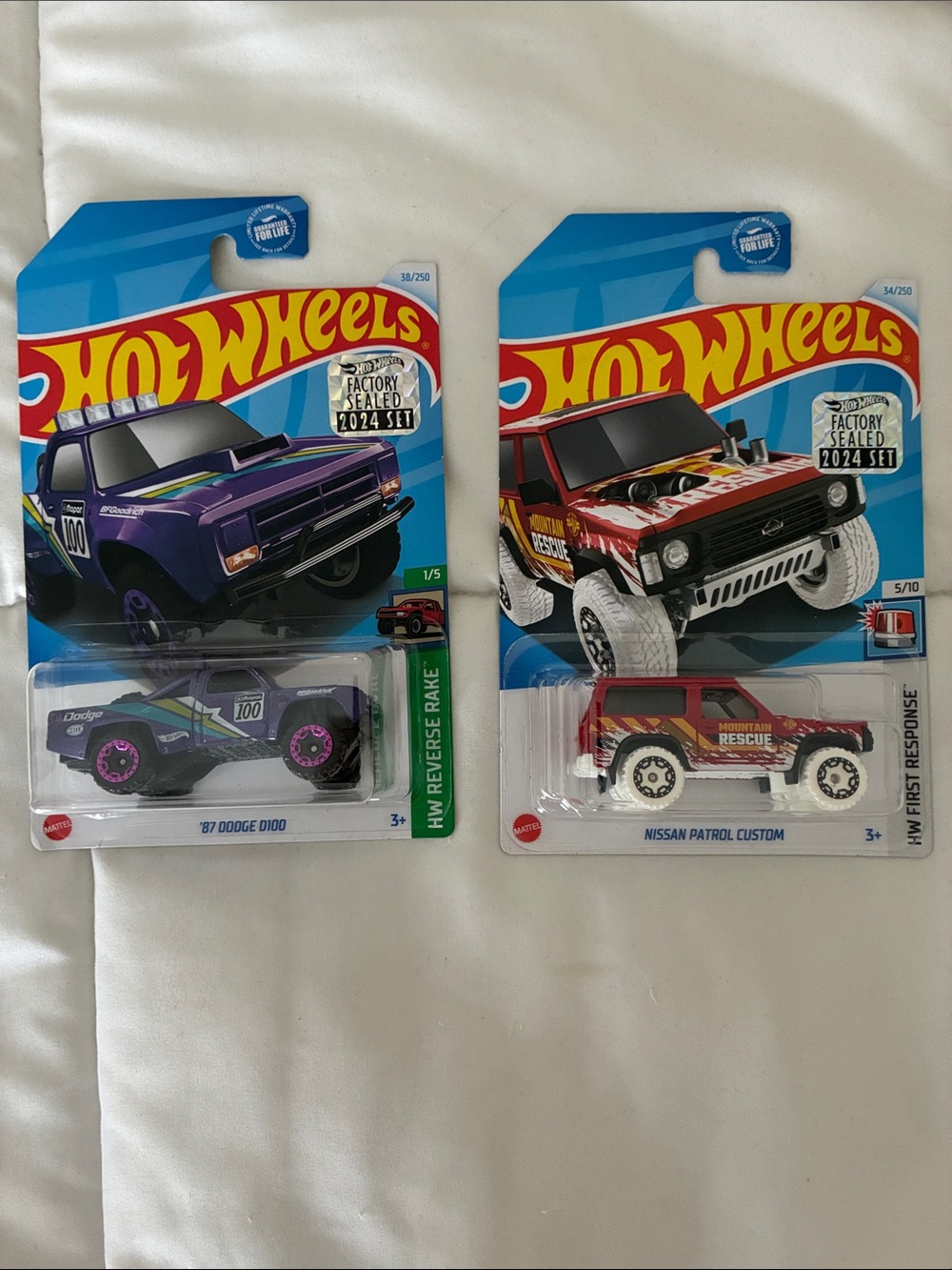 Factory sealed 2024 set - Purple '87 Dodge D100 & Red Nissan Patrol Custom